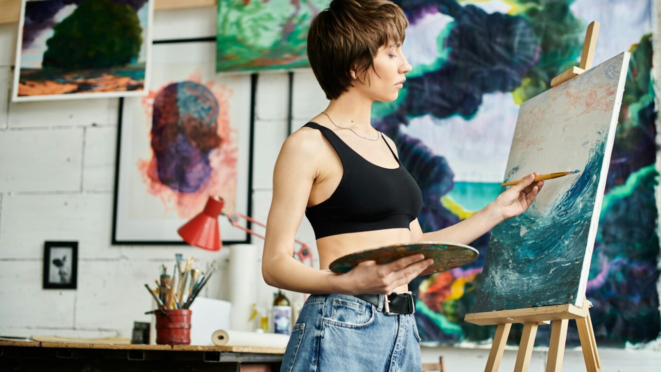 Creative Elegance: Woman in a Black Tank Top Painting