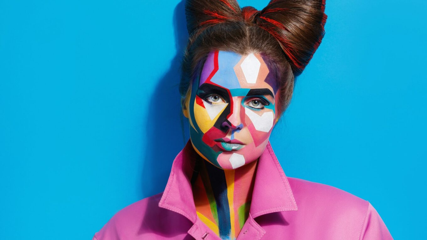 Model with a creative pop art makeup on her face.