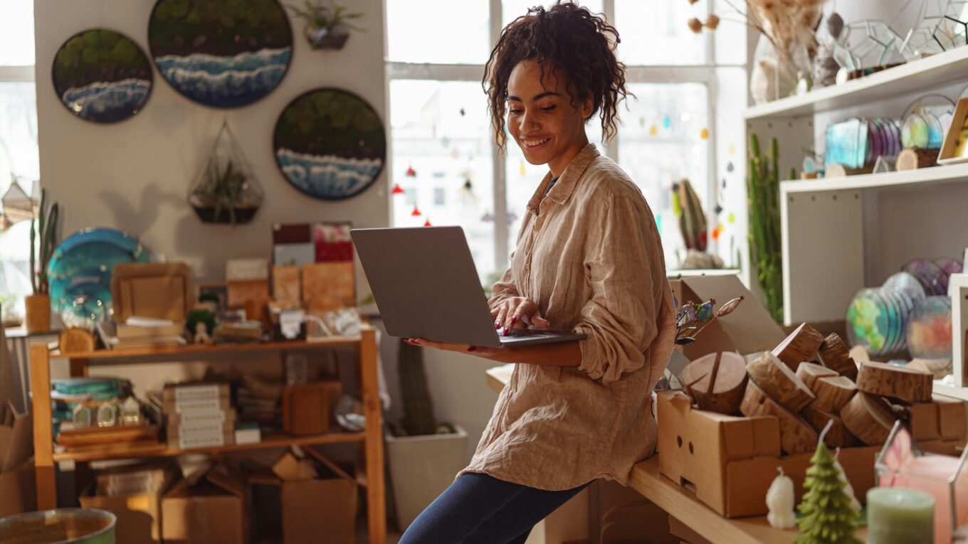 Successful female decorator working online from own art studio and check customers order