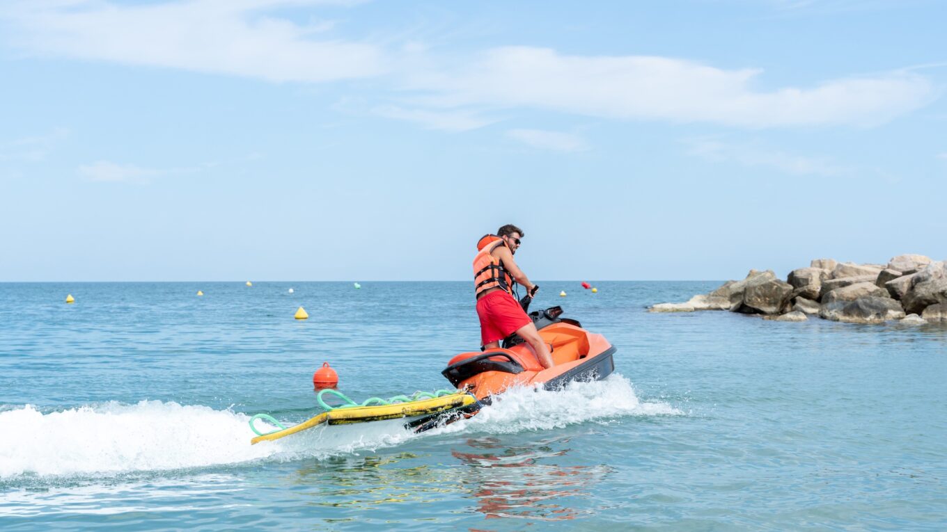 Lifeguard driving a Jet ski on duty on the sea